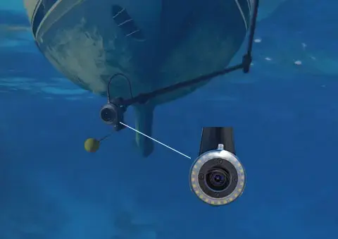 Underwater inspecting the hull of a boat from the deck